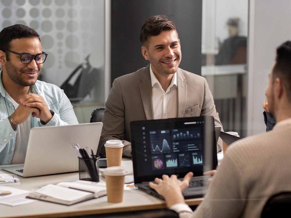 Men smiling in a business meeting