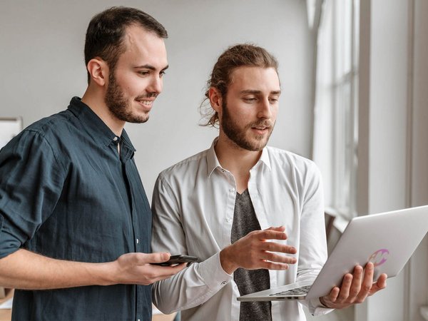 Two men, laptop