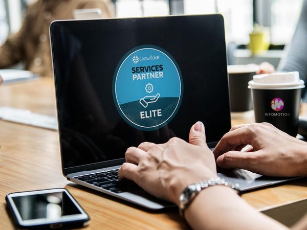 Laptop screen shows elite award