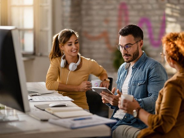 Colleagues sitting at a desk and smiling