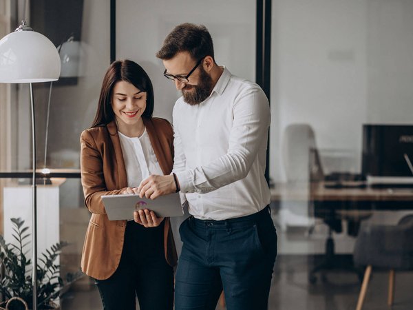 Two people, looking at tablet