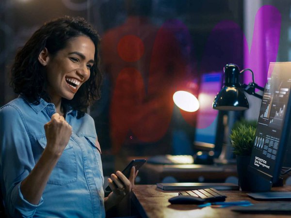 Woman looking happy in front of screen in office